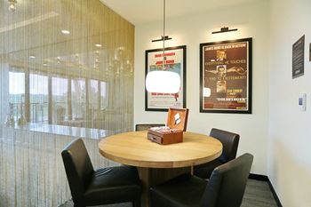 a conference room with a round table and black chairs